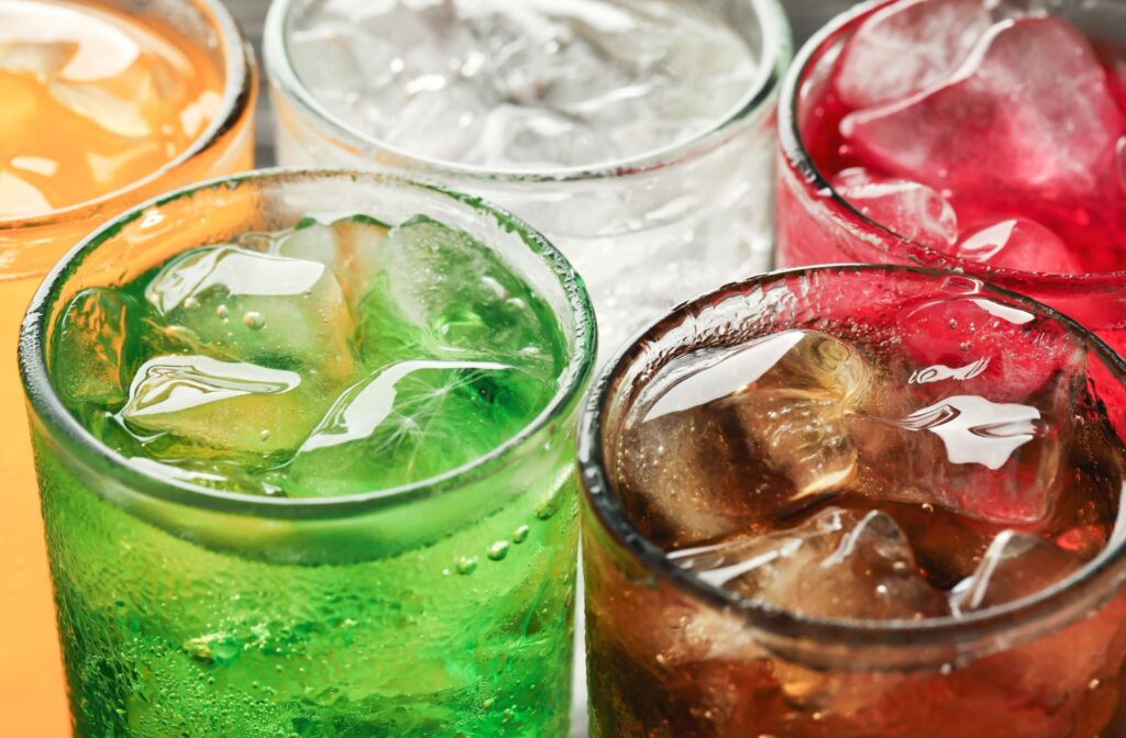 A mix of carbonated beverages that should be avoided after tooth extraction.