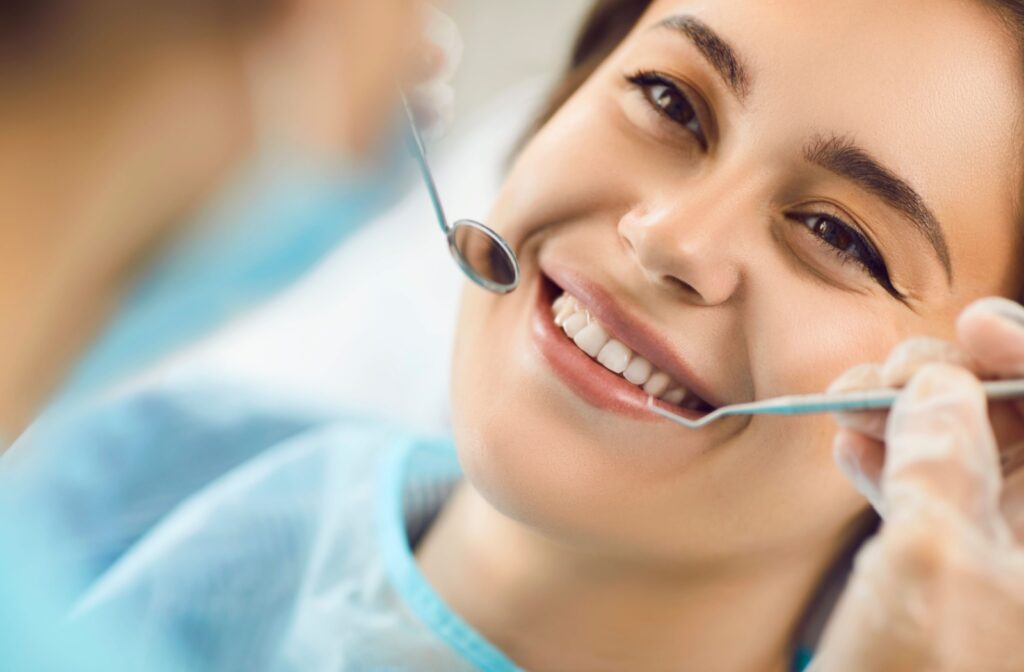 A smiling patient having their teeth cleaned by a dental hygienist in Markham.